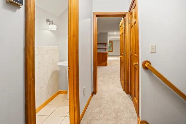 a view of an empty room with cabinet and a window