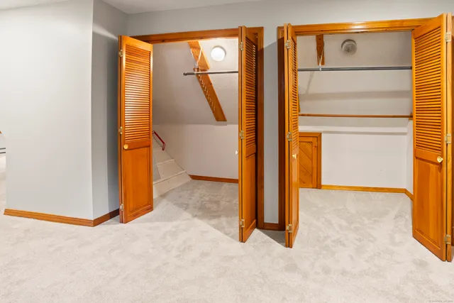 an empty room with windows and closet