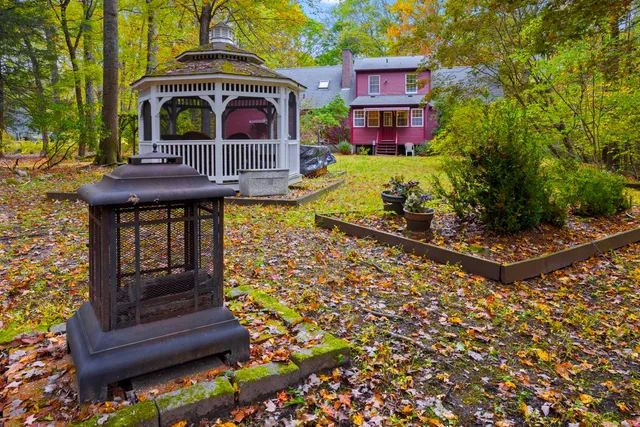 a backyard of a house with table and chairs
