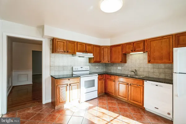 a kitchen with stainless steel appliances granite countertop a sink and cabinets