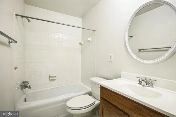 a bathroom with a granite countertop sink toilet a mirror and shower