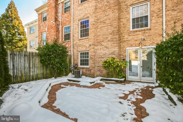 a backyard of a house with large trees and barbeque oven