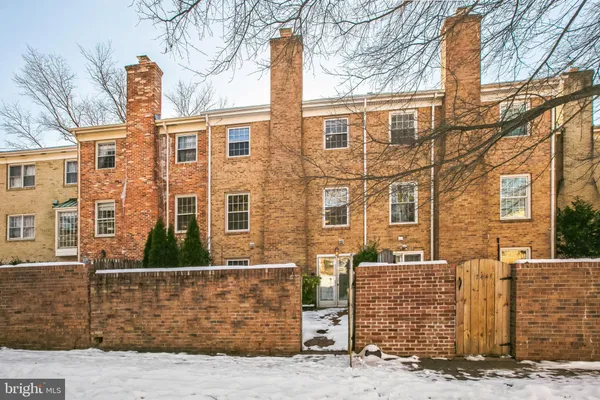 front view of a brick house with large windows