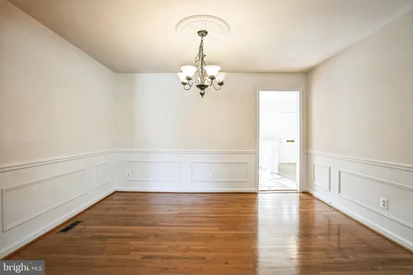 a view of a room with wooden floor and a window