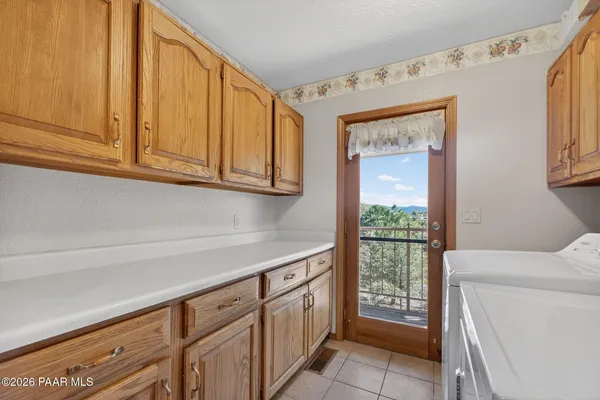 a kitchen with stainless steel appliances granite countertop a kitchen island a stove a refrigerator a sink a dining table and chairs