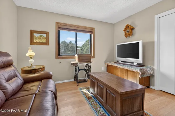 a living room with furniture a dining table and a potted plant