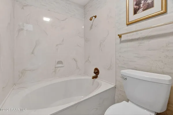 a view of house with backyard and trees