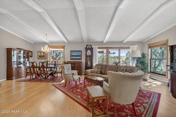 a bedroom with a bed and a table in it with window