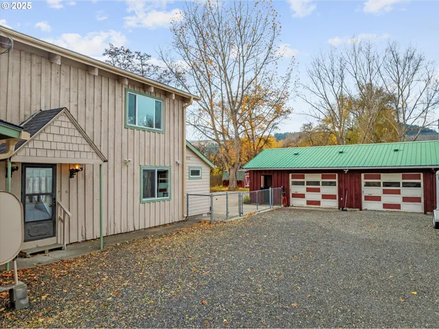 front view of a house with a large tree