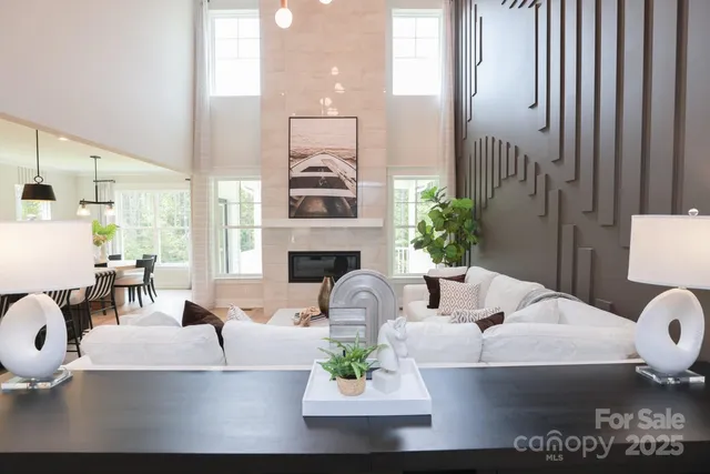 a living room with furniture fireplace and a large window