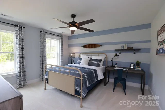 a bedroom with a bed lamps and window