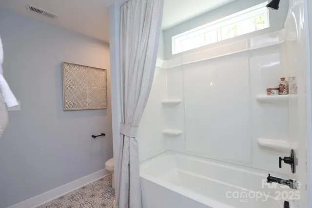 a bathroom with a toilet and a bathtub