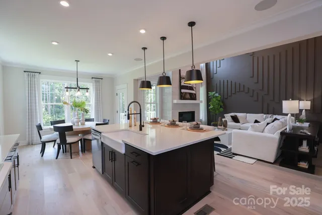 a large kitchen with kitchen island a sink table and chairs