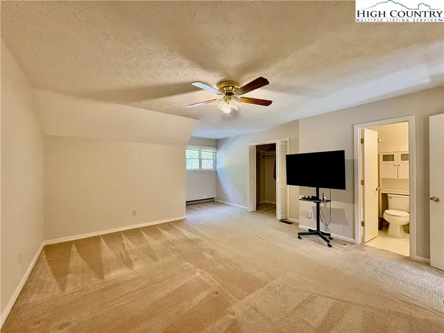 a view of a livingroom with a flat screen tv and a ceiling fan