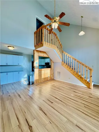 a view of an entryway with wooden floor
