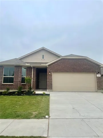 a front view of house with a garden