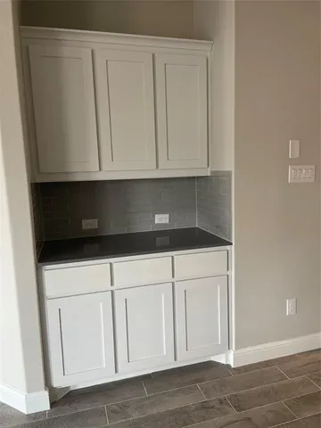 a kitchen with white cabinets and white appliances