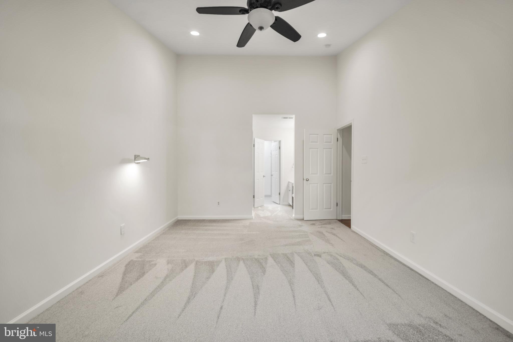 2402 Waterford Road, Unit 94 Yardley, PA 19067 - Photo 13 of 28 an empty room with a ceiling fan and window