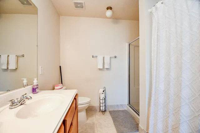 a bathroom with a sink a toilet and mirror