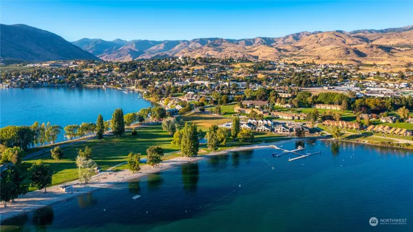an aerial view of residential houses with outdoor space and river
