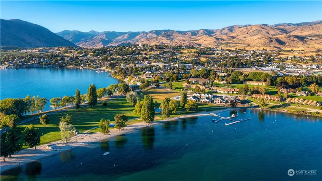 an aerial view of residential houses with outdoor space and river