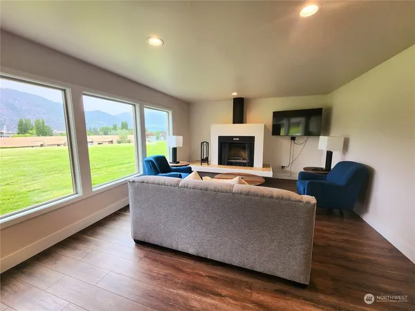 a living room with furniture a flat screen tv and a fireplace