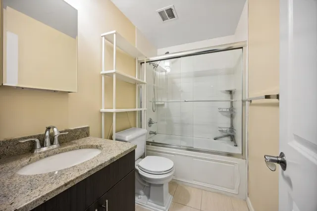 a kitchen with stainless steel appliances kitchen island granite countertop a stove and a refrigerator