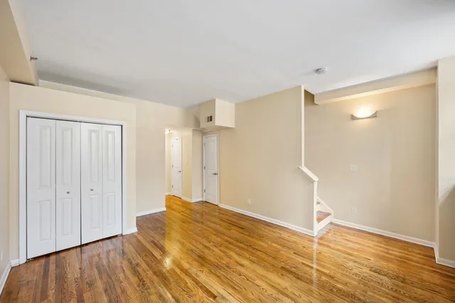a view of empty room with wooden floor