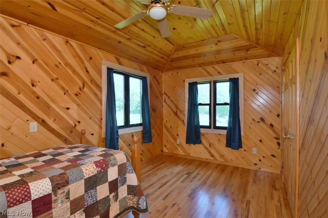 15227 Leroy Road Thompson, OH 44086 - Photo 26 of 50 Bedroom with beautiful hardwood floors, vaulted ceiling, ceiling fan, two different closets and two windows.