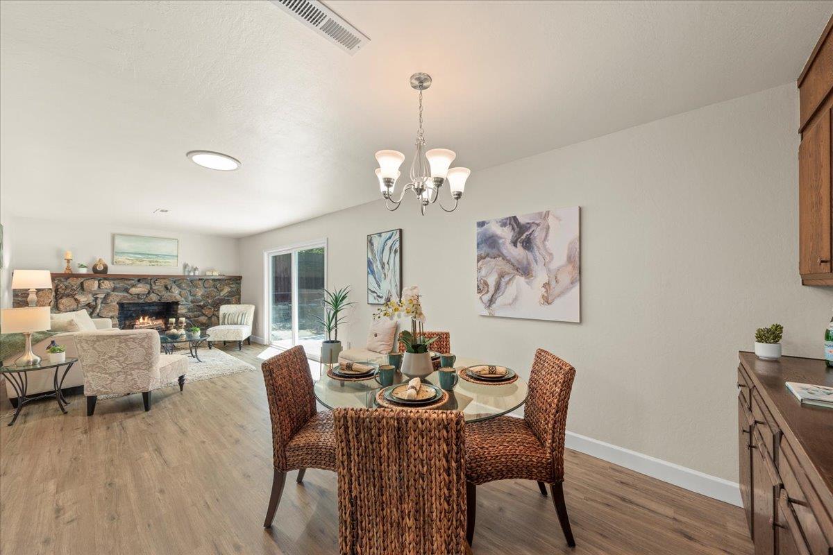 1300 Amesti Road Watsonville, CA 95076 - Photo 11 of 34 a dining room with furniture a chandelier and wooden floor
