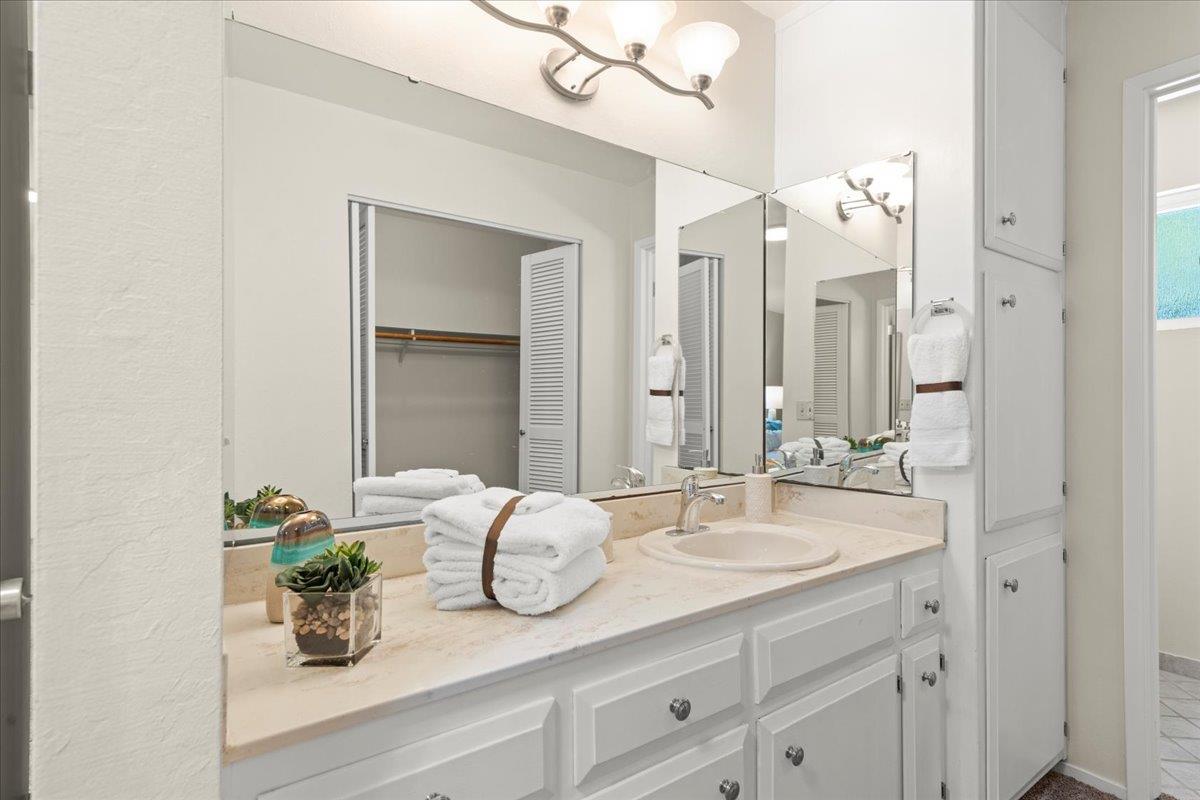 1300 Amesti Road Watsonville, CA 95076 - Photo 18 of 34 a bathroom with a granite countertop sink a mirror and a shower