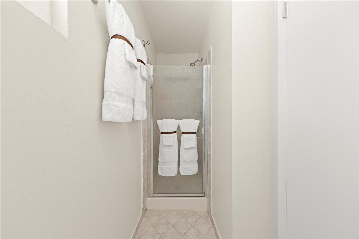1300 Amesti Road Watsonville, CA 95076 - Photo 21 of 34 a bathroom with a glass shower door