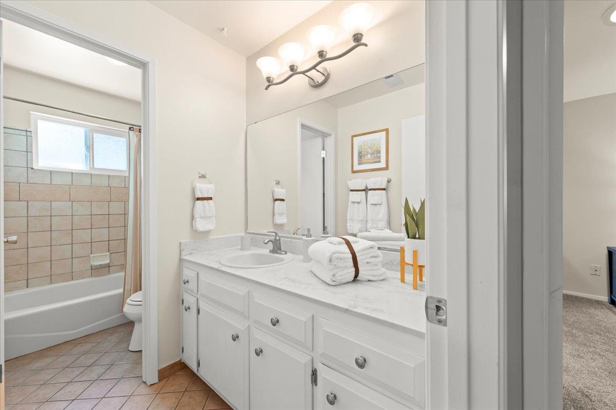 1300 Amesti Road Watsonville, CA 95076 - Photo 26 of 34 a bathroom with a granite countertop sink mirror and bathtub