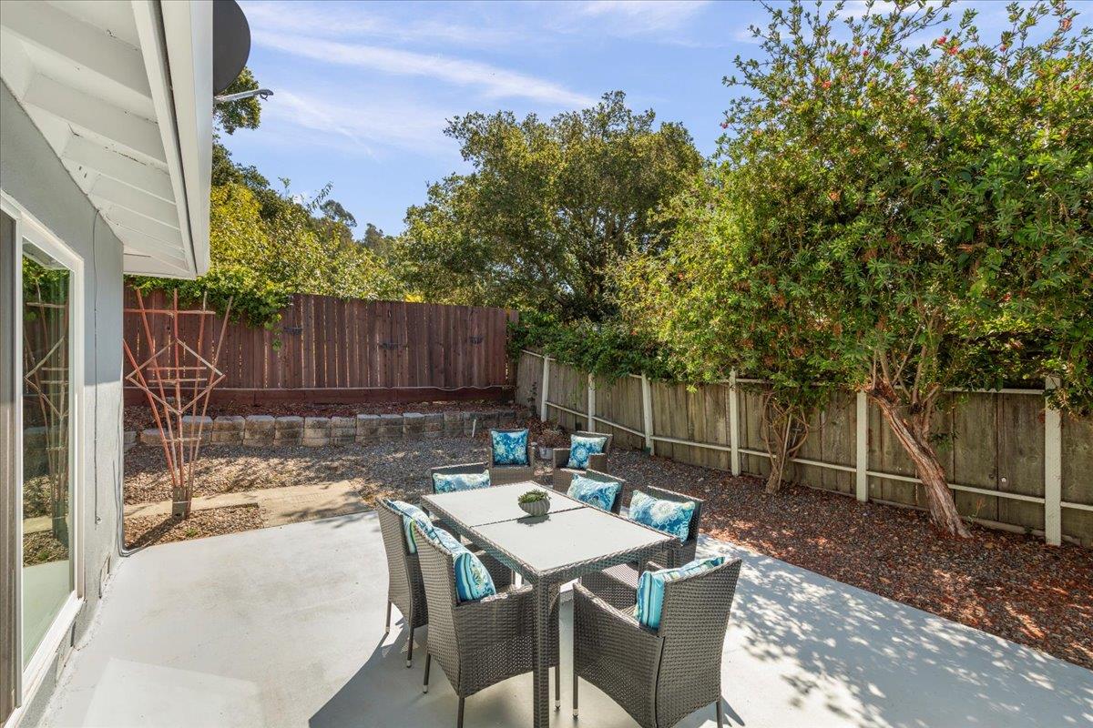 1300 Amesti Road Watsonville, CA 95076 - Photo 29 of 34 a view of a patio with table and chairs with wooden fence and plants