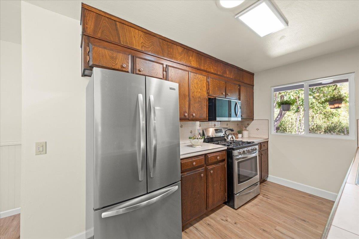 1300 Amesti Road Watsonville, CA 95076 - Photo 5 of 34 a kitchen with stainless steel appliances granite countertop a refrigerator a stove a sink and a window