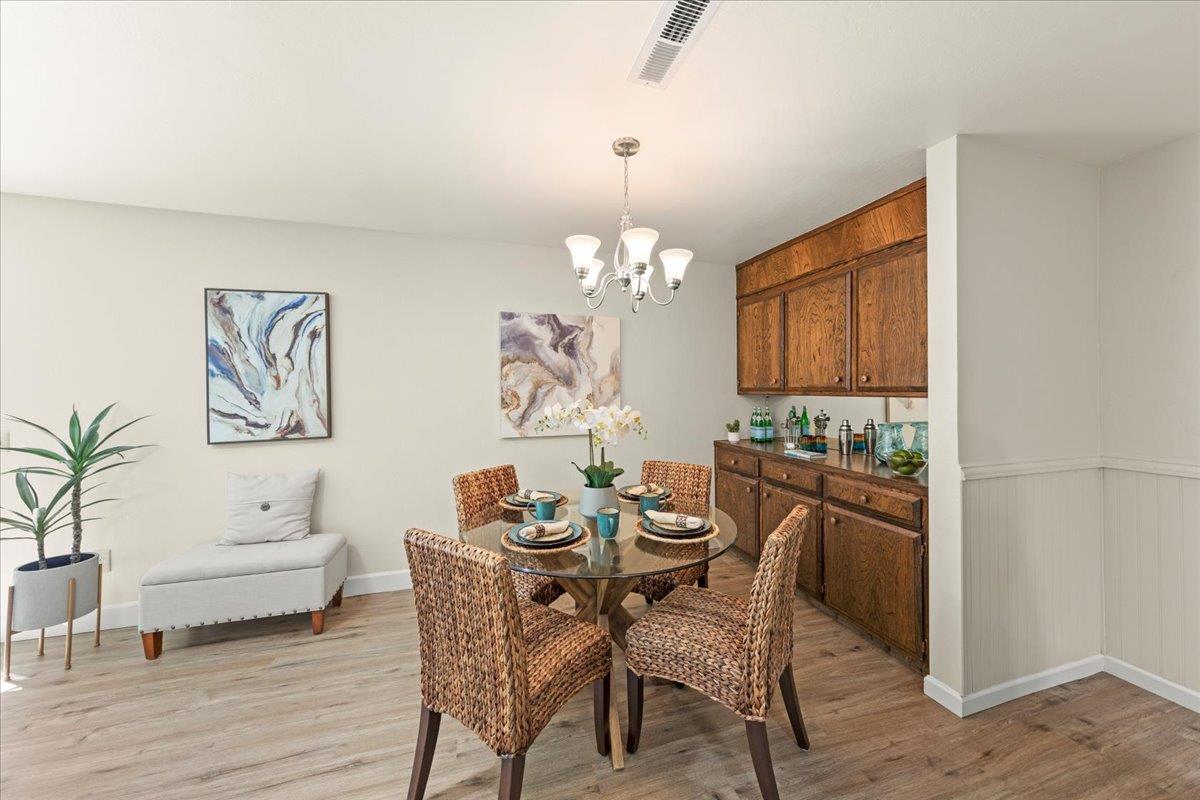 1300 Amesti Road Watsonville, CA 95076 - Photo 10 of 34 a dining room with furniture a chandelier and wooden floor