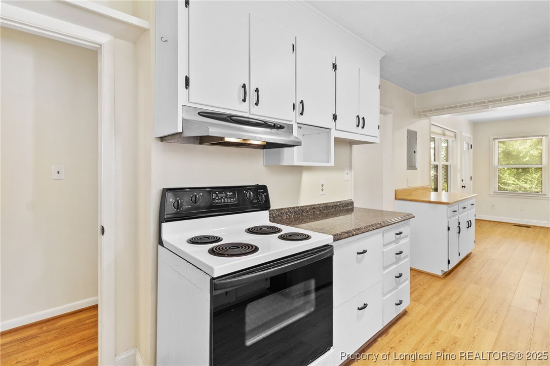 1512 Crescent Drive Spring Lake, NC 28390 - Photo 12 of 36 a kitchen with granite countertop a stove sink and cabinets