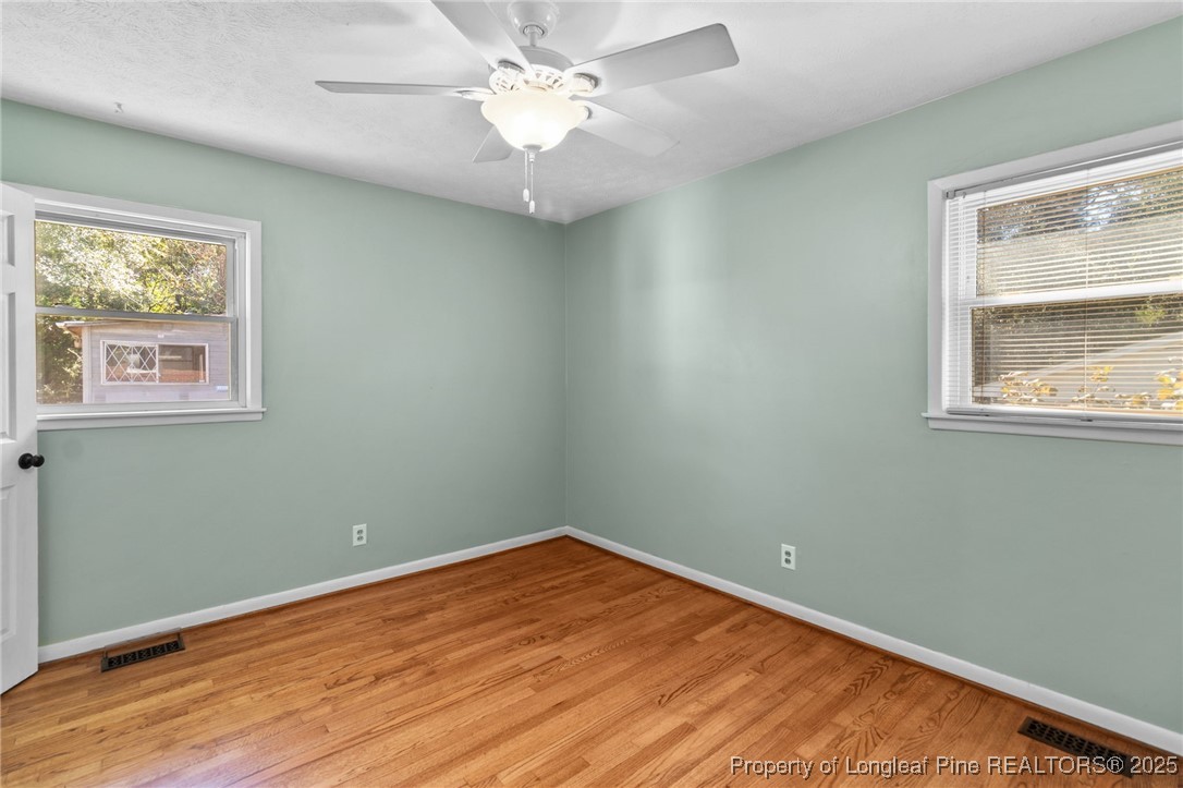1512 Crescent Drive Spring Lake, NC 28390 - Photo 20 of 36 wooden floor in an empty room with a window
