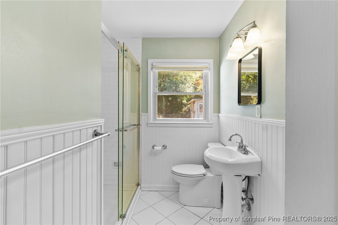 1512 Crescent Drive Spring Lake, NC 28390 - Photo 27 of 36 a bathroom with a sink toilet and mirror