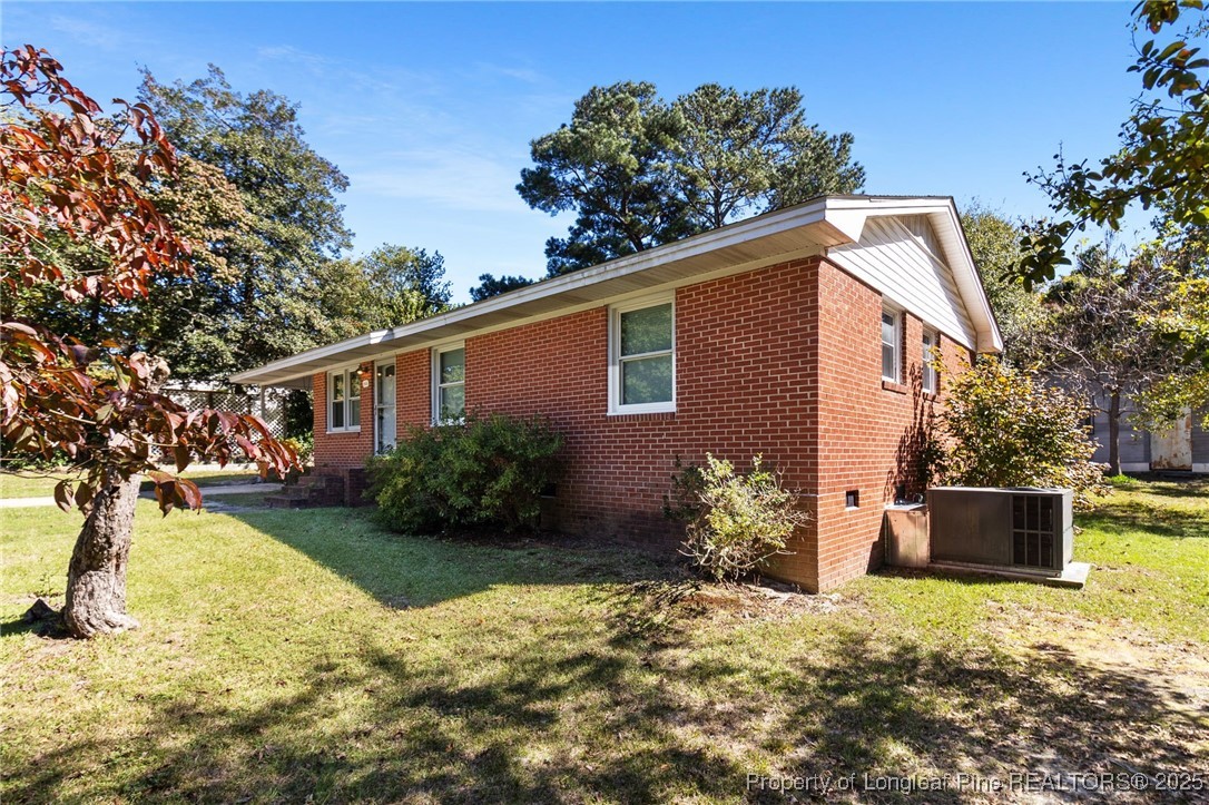 1512 Crescent Drive Spring Lake, NC 28390 - Photo 4 of 36 a front view of a house with a yard and a garage