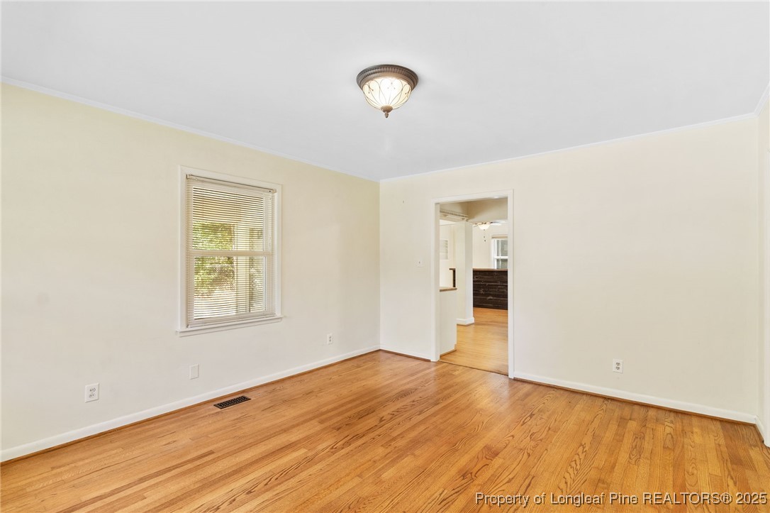 1512 Crescent Drive Spring Lake, NC 28390 - Photo 7 of 36 a view of an empty room with wooden floor and a window