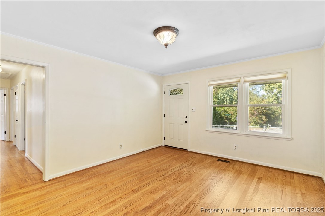 1512 Crescent Drive Spring Lake, NC 28390 - Photo 8 of 36 a view of an empty room with wooden floor and a window