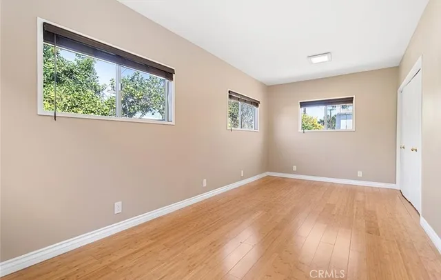 a view of room with wooden floor and window
