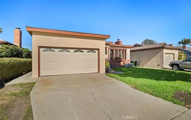 a view of garage with a yard