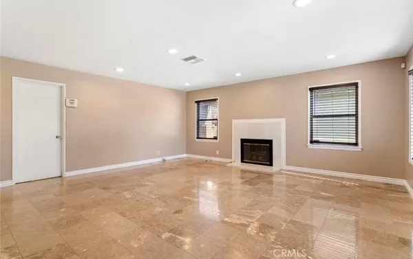 a view of a livingroom with a fireplace and window
