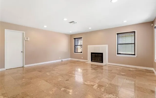 a view of a livingroom with a fireplace and window