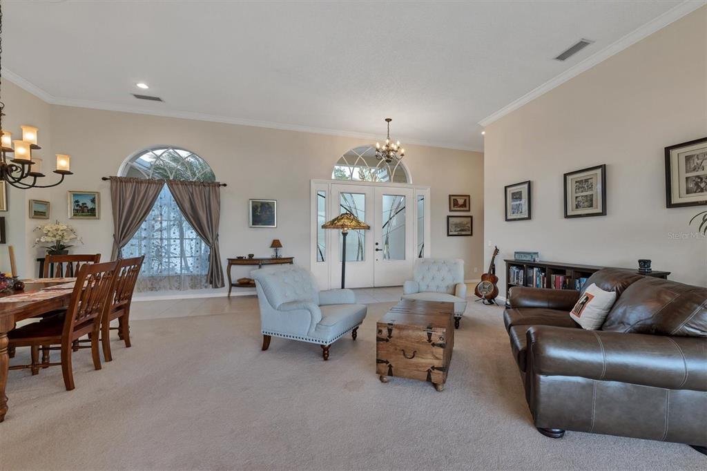 9910 Laurel Valley Ave Circle Bradenton, FL 34202 - Photo 13 of 37 a living room with furniture and a chandelier
