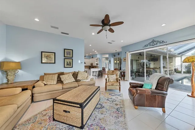 a kitchen with stainless steel appliances granite countertop a table chairs sink and cabinets