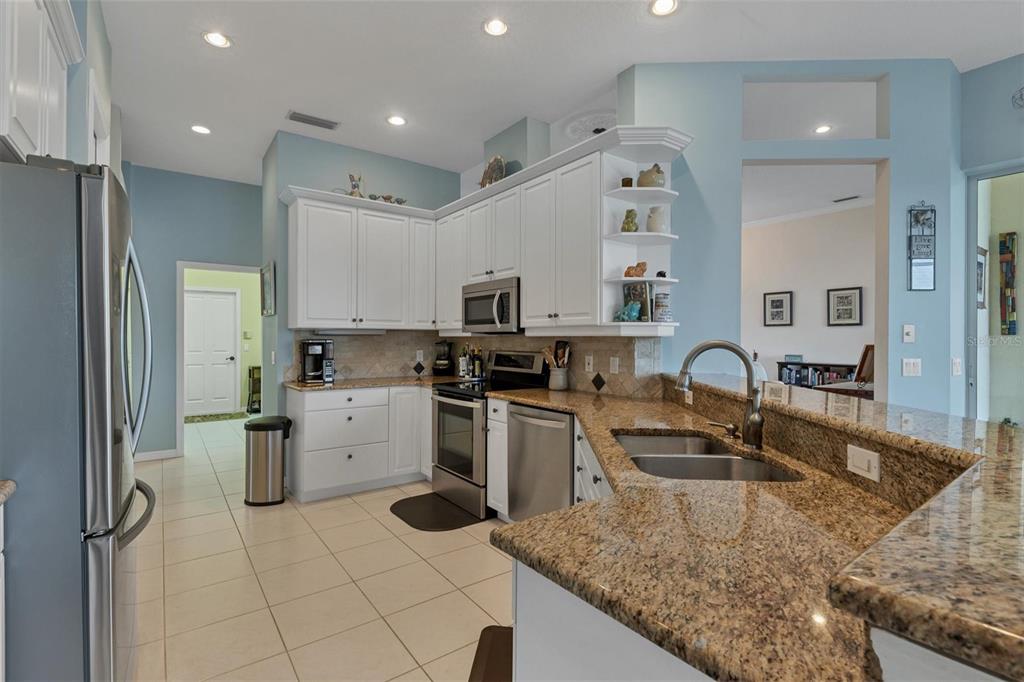 9910 Laurel Valley Ave Circle Bradenton, FL 34202 - Photo 21 of 37 a kitchen with a sink stove and refrigerator