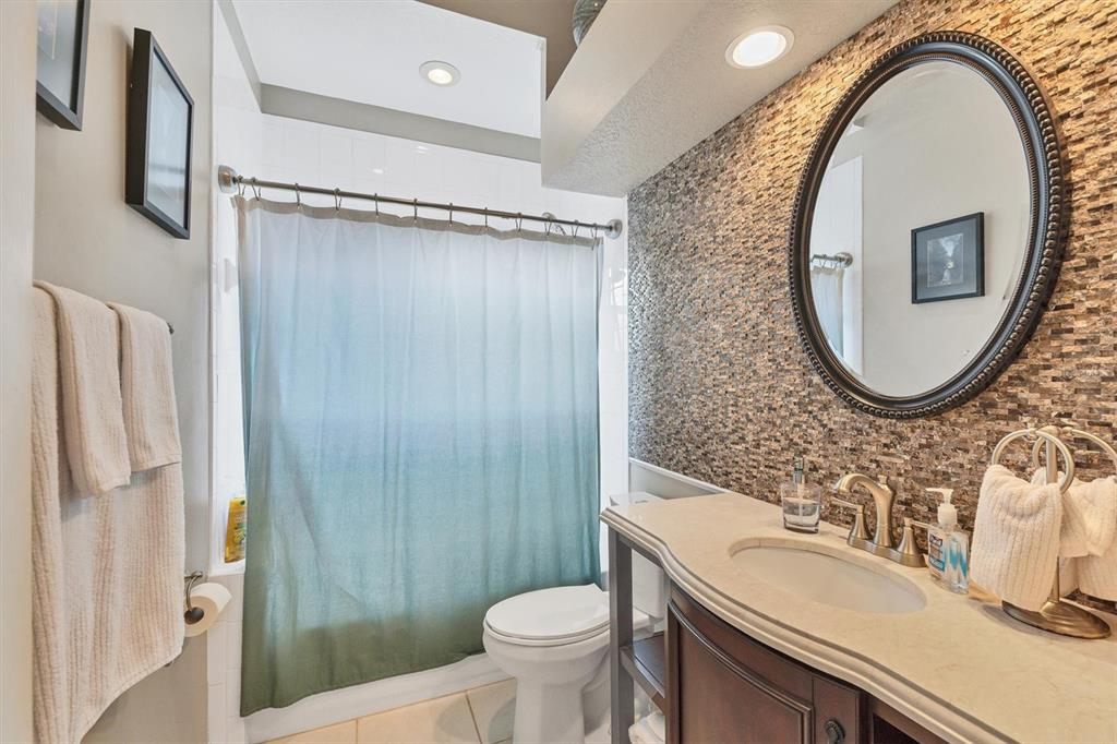 9910 Laurel Valley Ave Circle Bradenton, FL 34202 - Photo 27 of 37 a bathroom with a sink a mirror a toilet and a shower